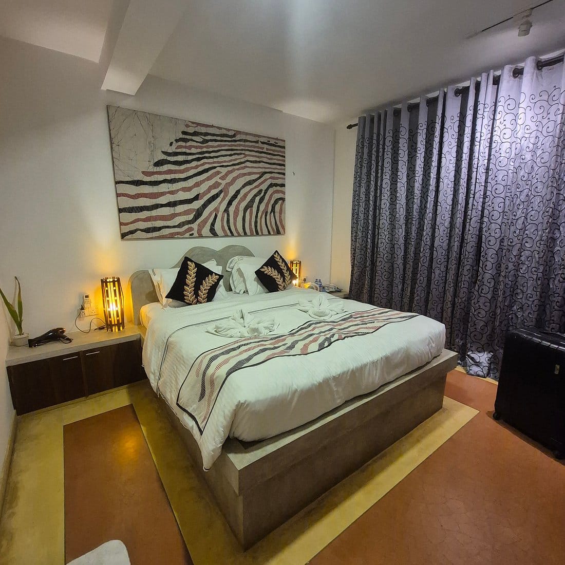 Gangula Villa room featuring a beautifully dressed bed with batik décor