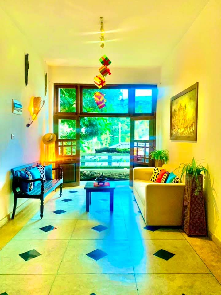 Couple in a Gangula Villa room with colourful Kandyan batik wall art